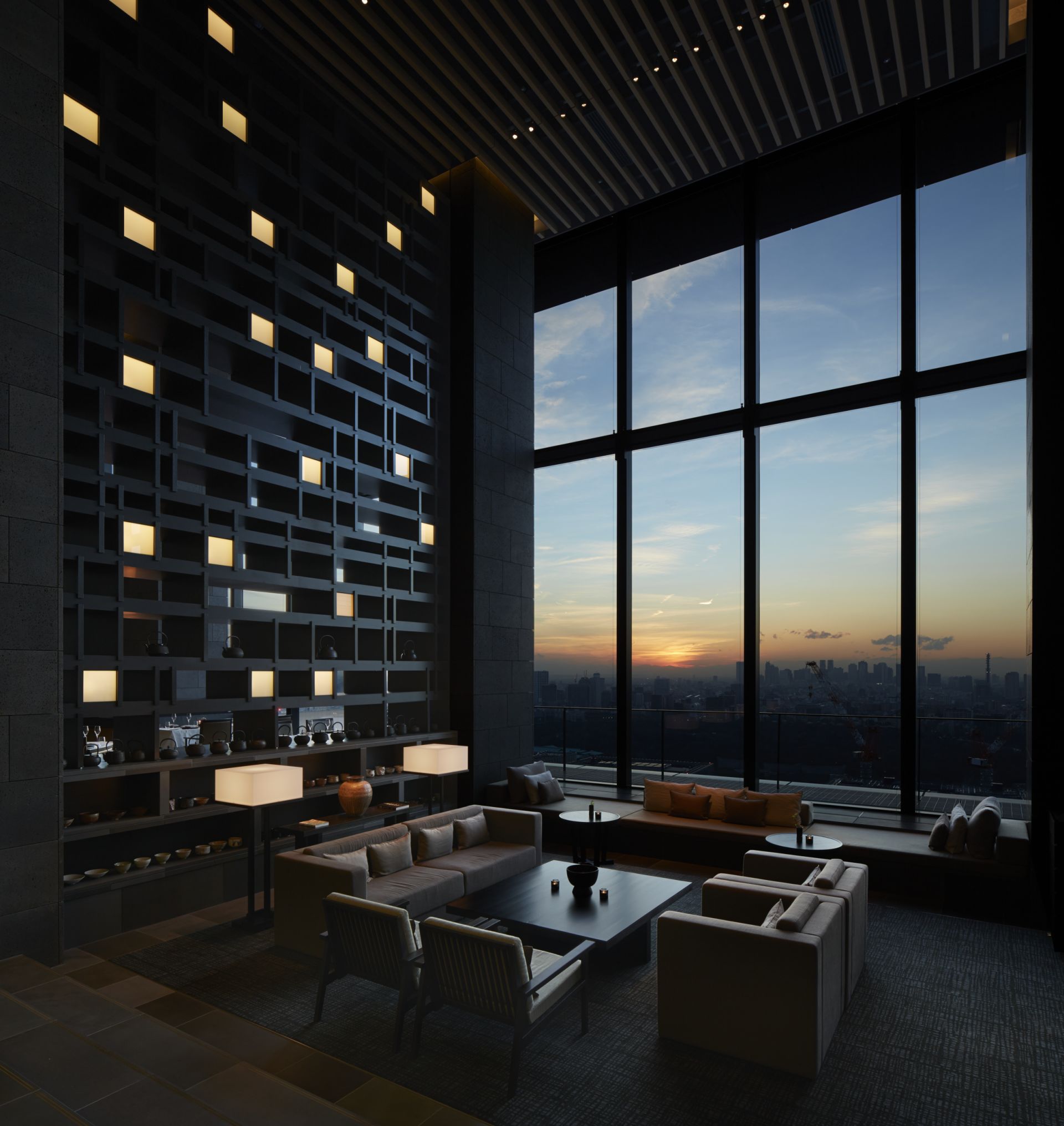 Aman Tokyo lounge overlooking the skyline at sunset
