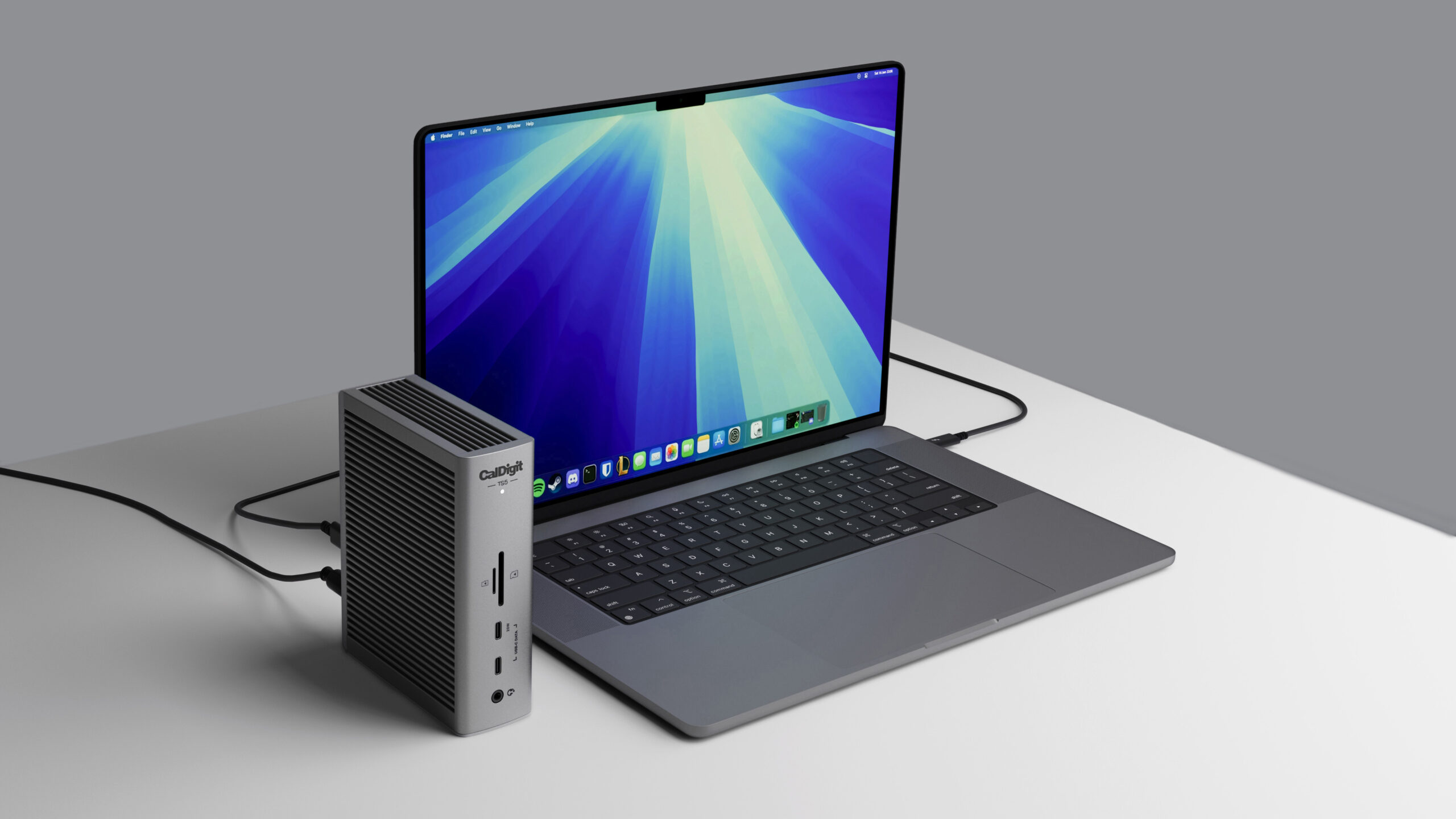 CalDigit TS5 connected beside a laptop in the manufacturer setup