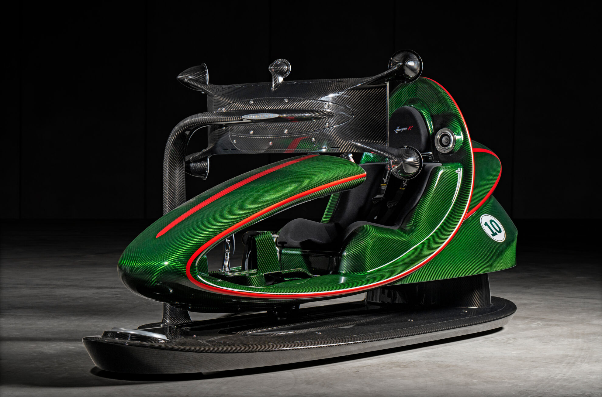 Pagani Huayra R Simulator in green carbon fibre with red trim, integrated cockpit, curved monitor and motion base