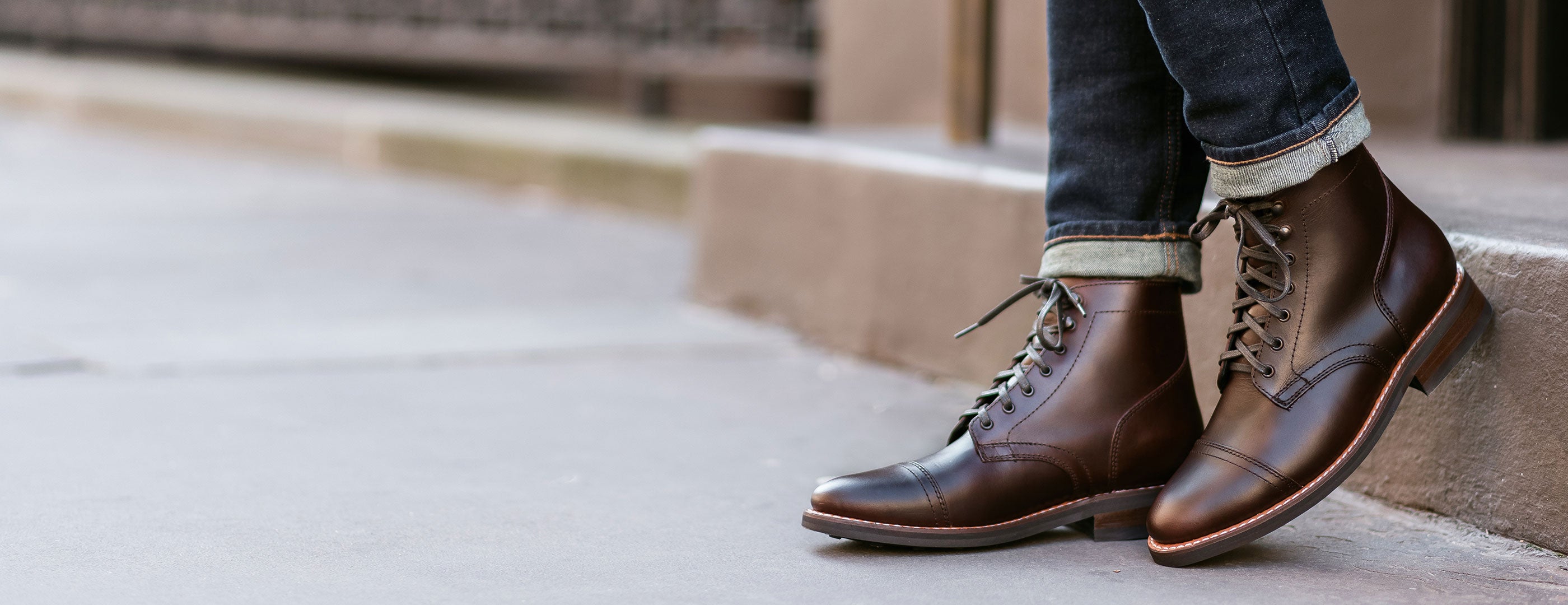 Thursday Captain boots in Brown, worn with cuffed denim